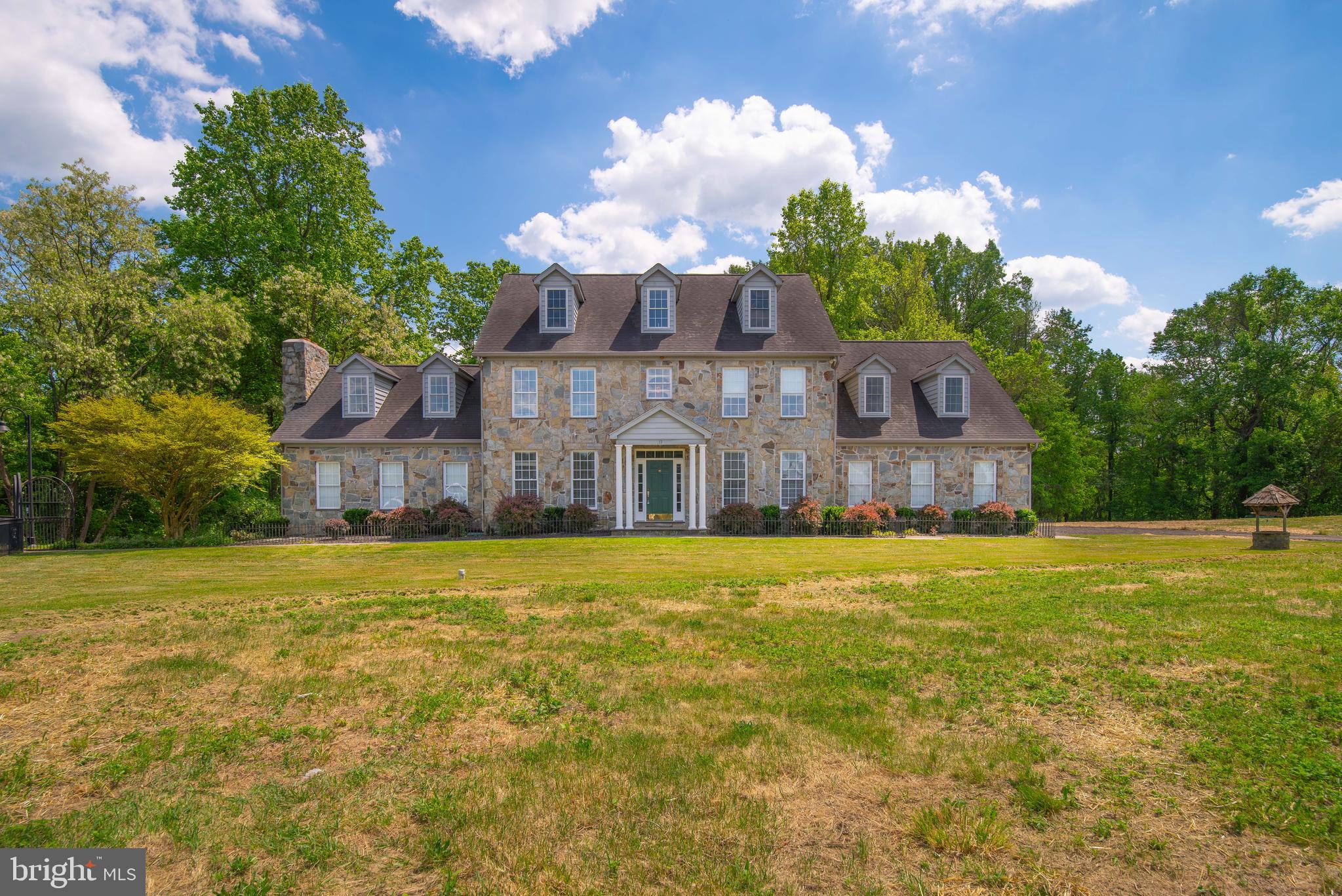 a front view of a house with a big yard