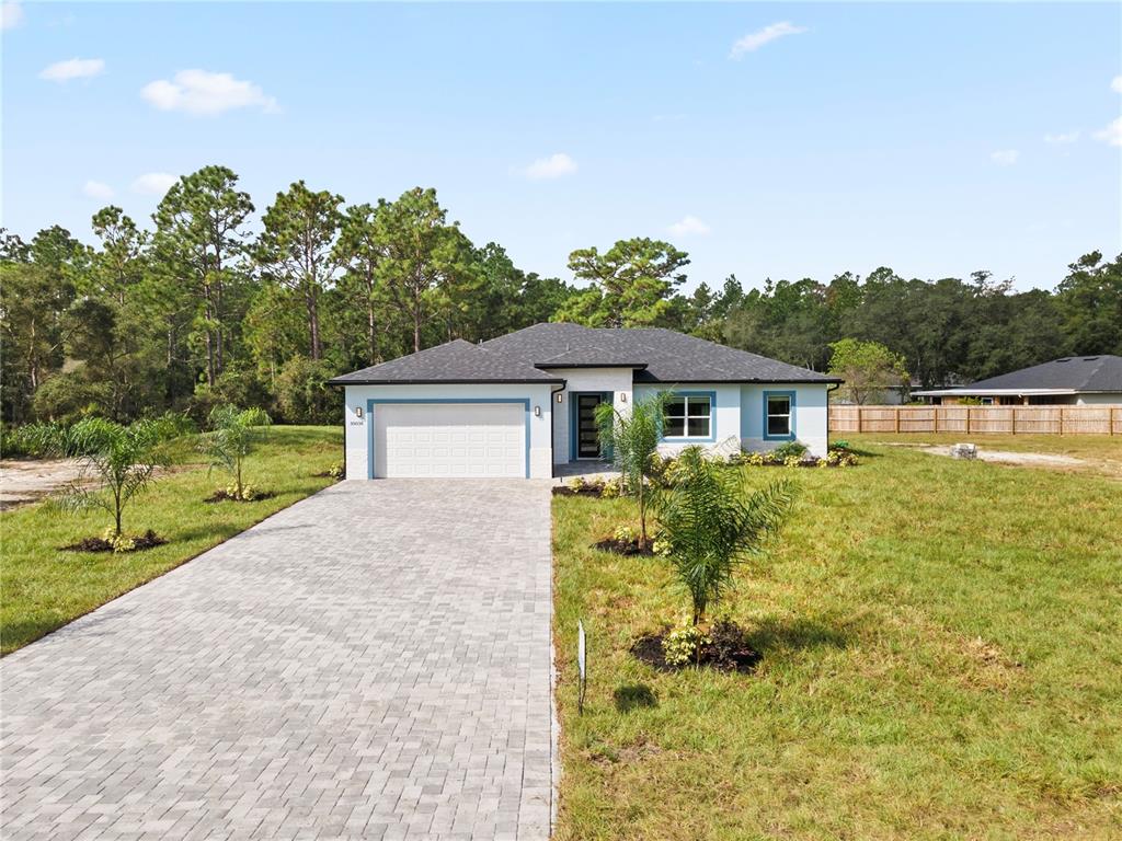 a front view of house with yard and green space