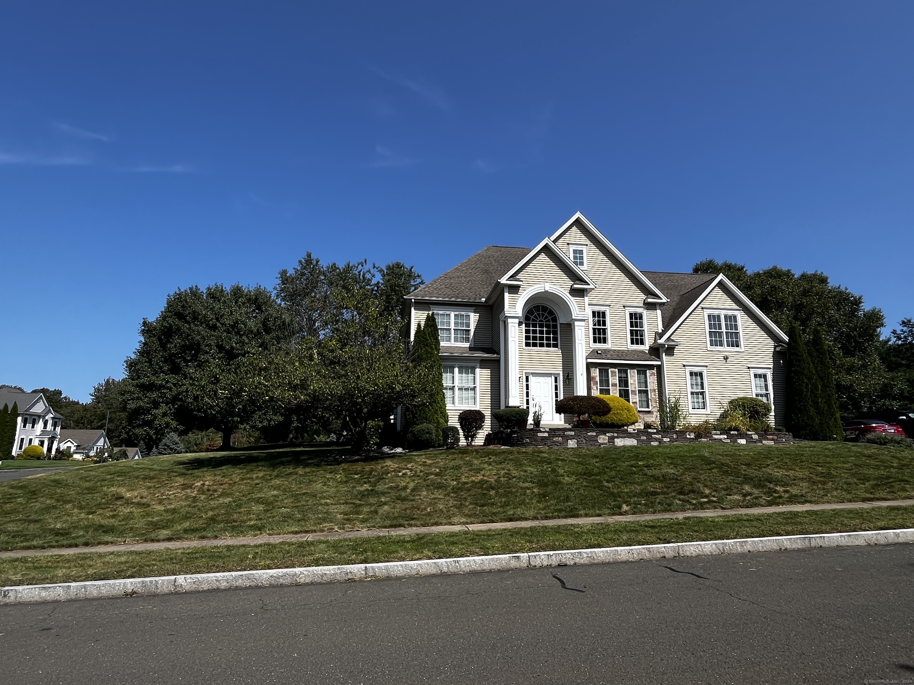 a front view of a house with a yard