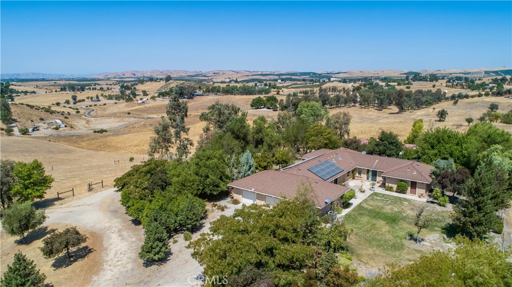 an aerial view of a house with a yard