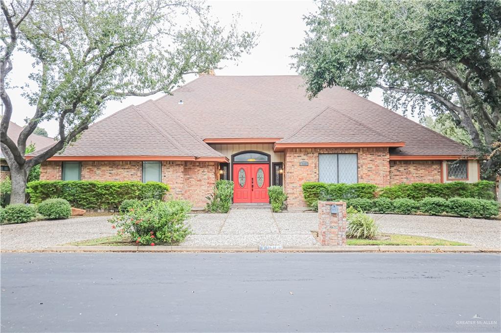 a front view of a house with a yard and a garage