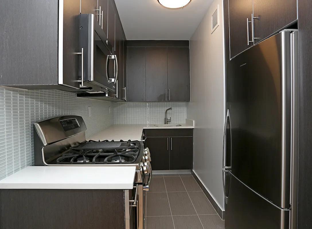 a kitchen with a refrigerator and a sink