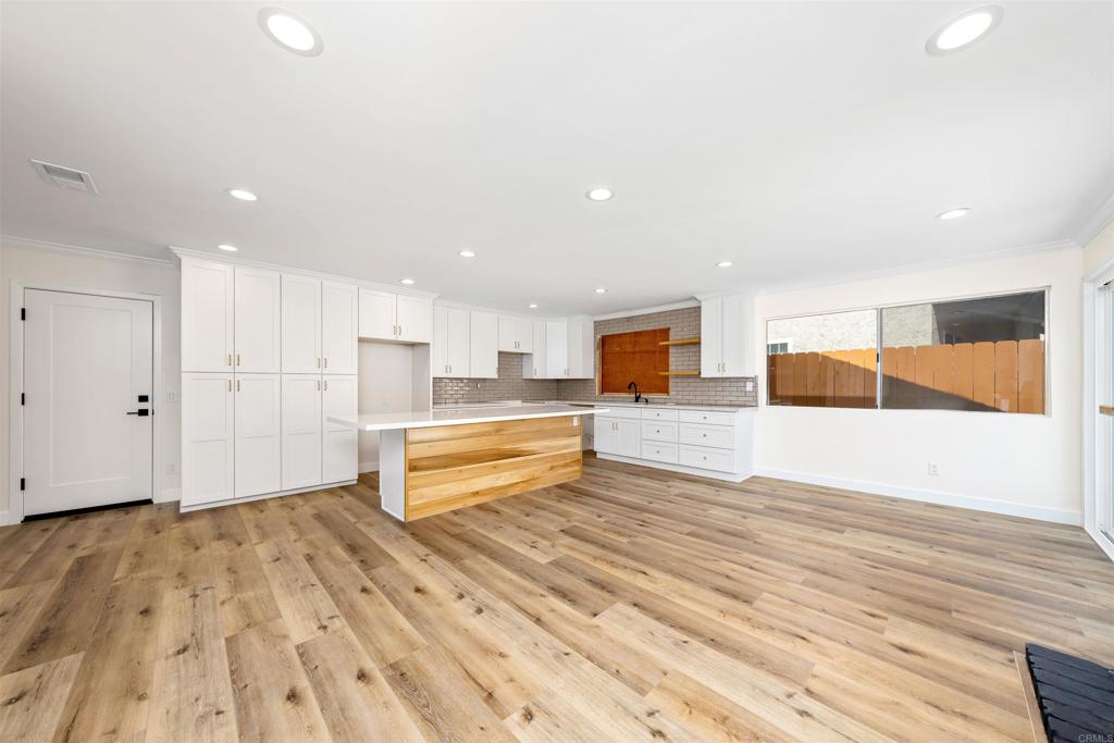 a view of a kitchen with wooden floor