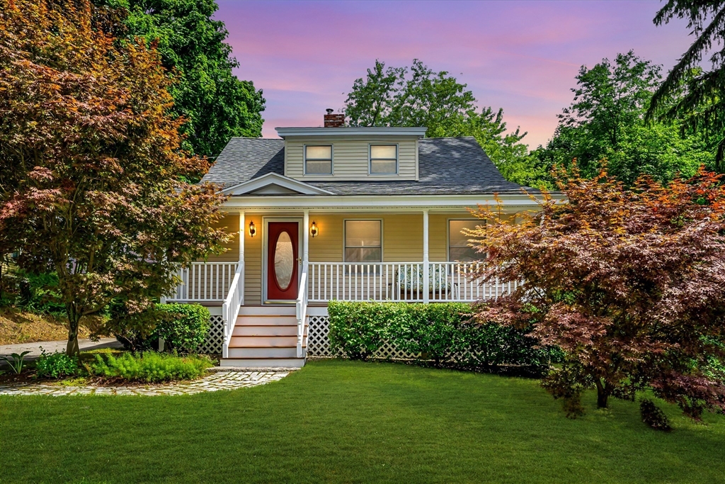 a front view of a house with garden