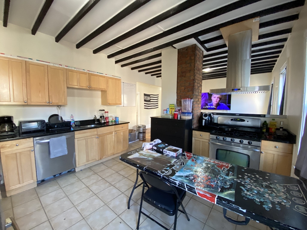 a kitchen with a stove a sink and a refrigerator