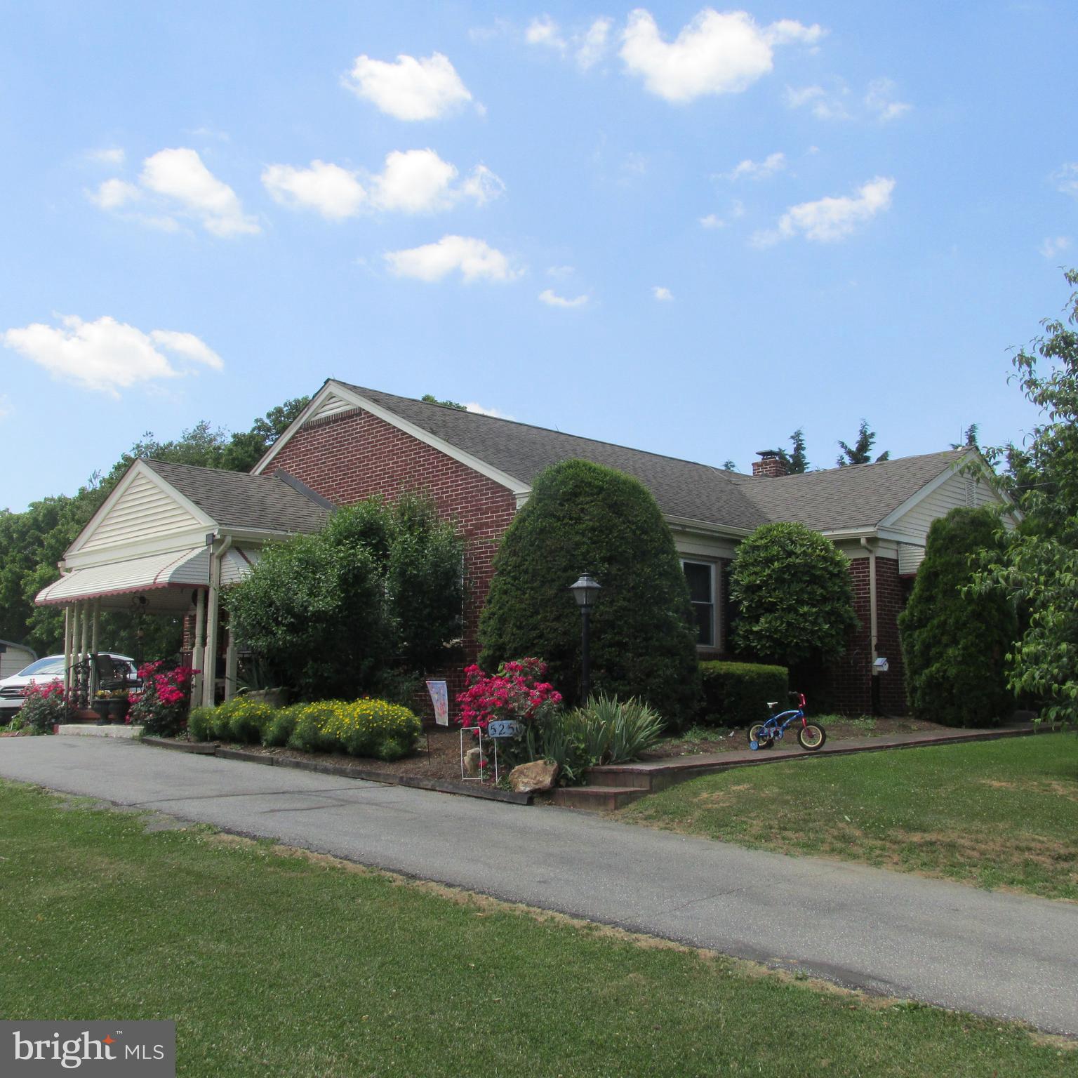 a view of a house with a garden and plants