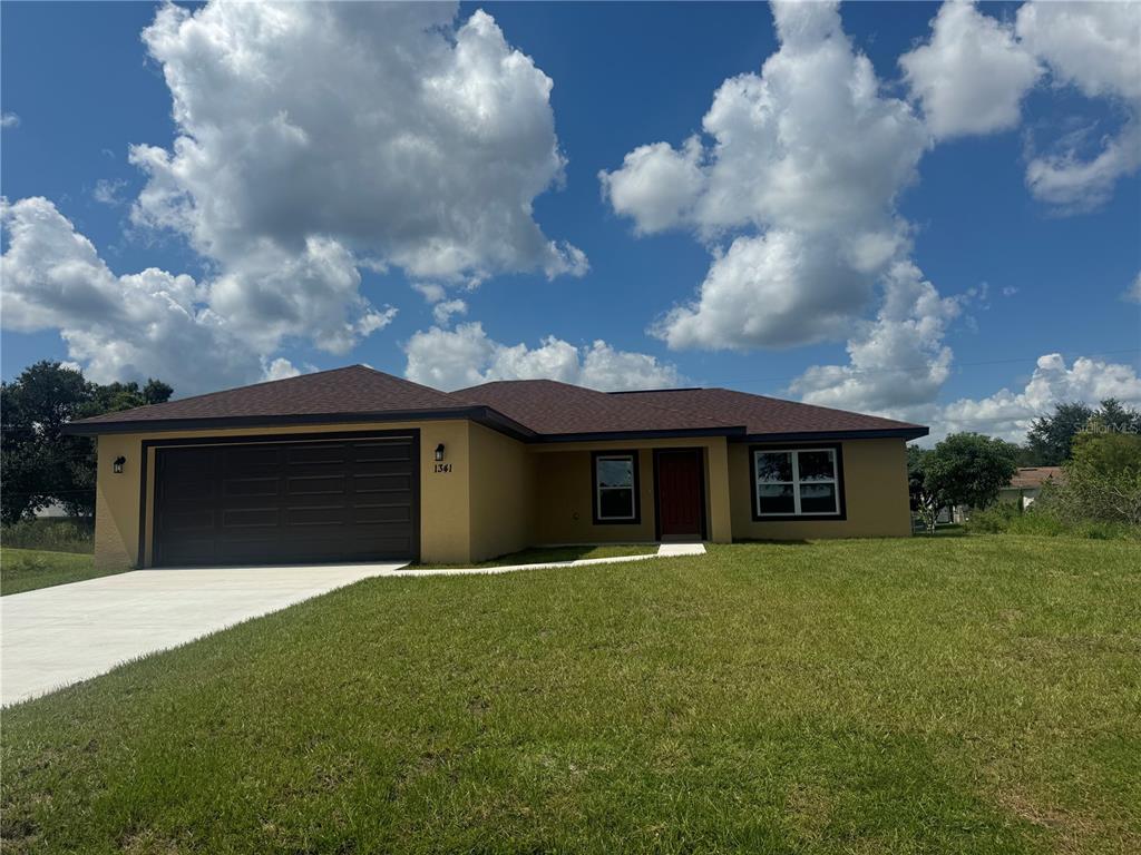 a front view of house with yard and green space