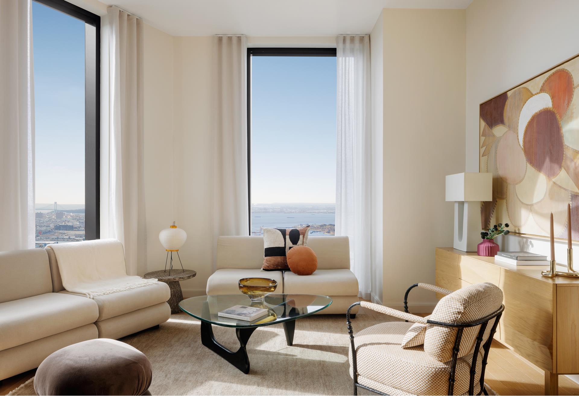 a living room with furniture wooden floor and a large window