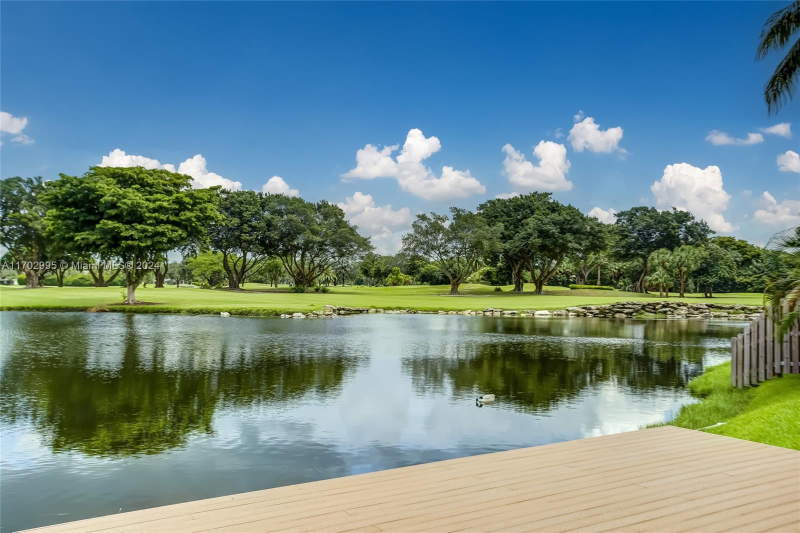 a view of a lake with a house in the background