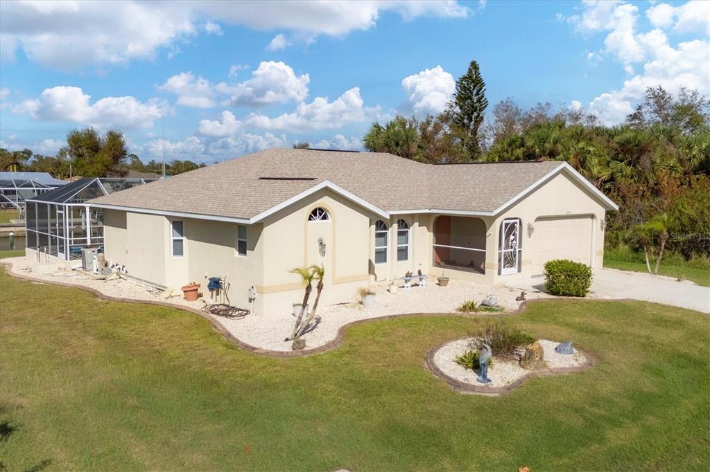 a aerial view of a house with a yard patio and fire pit