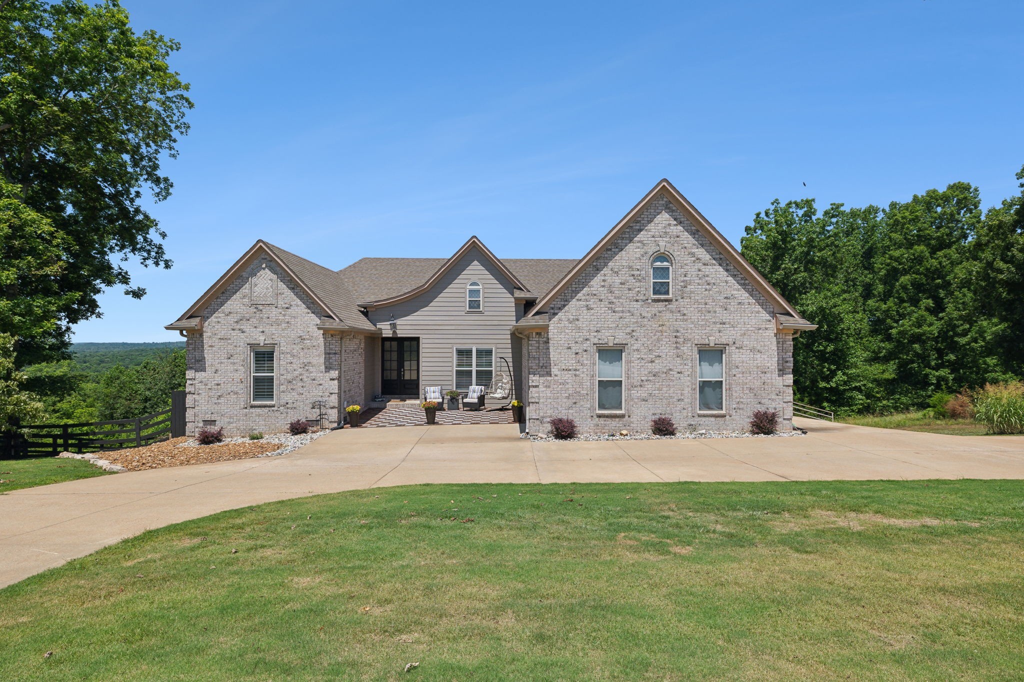 a front view of a house with yard and green space