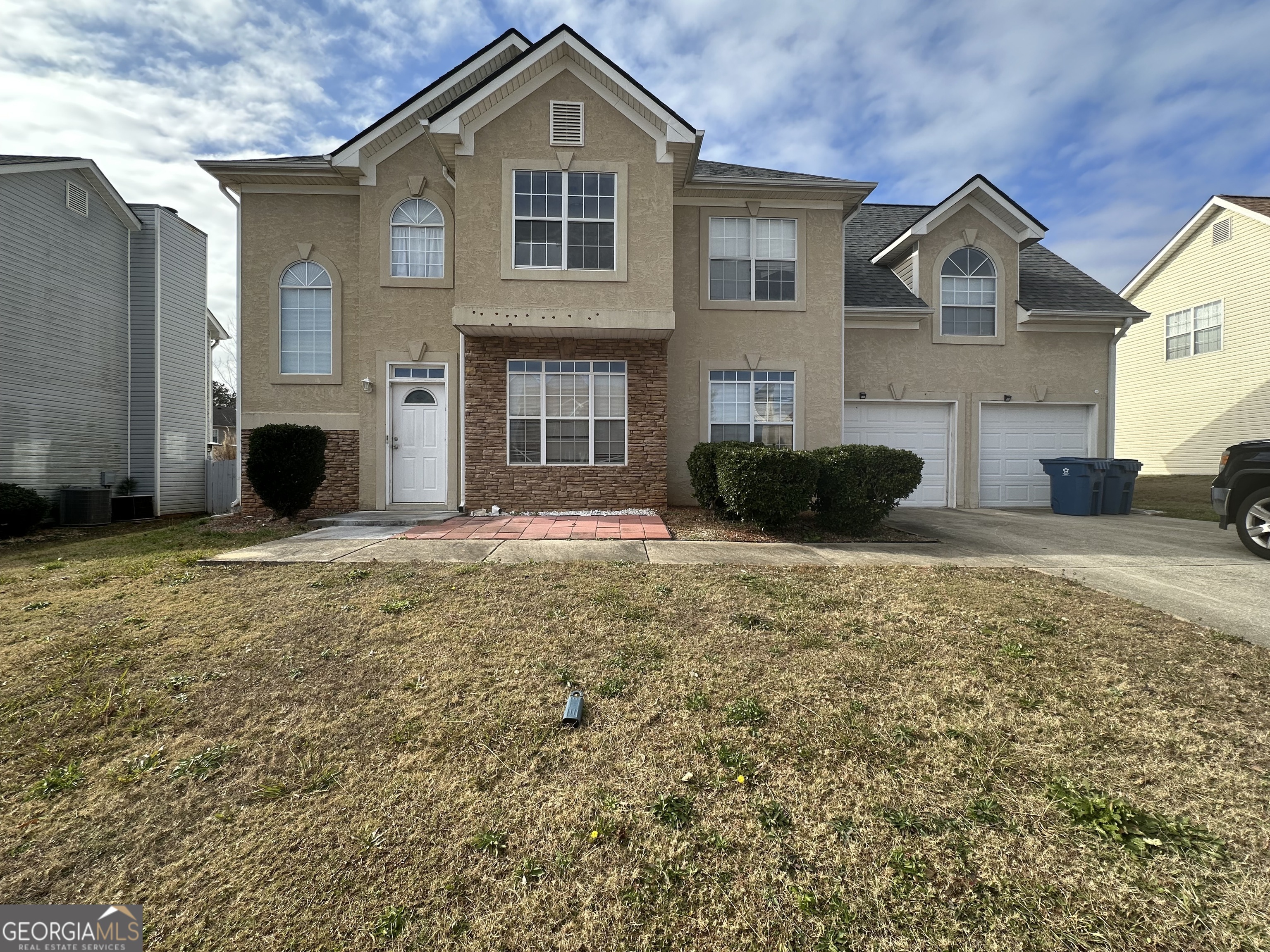 a front view of a house with a yard