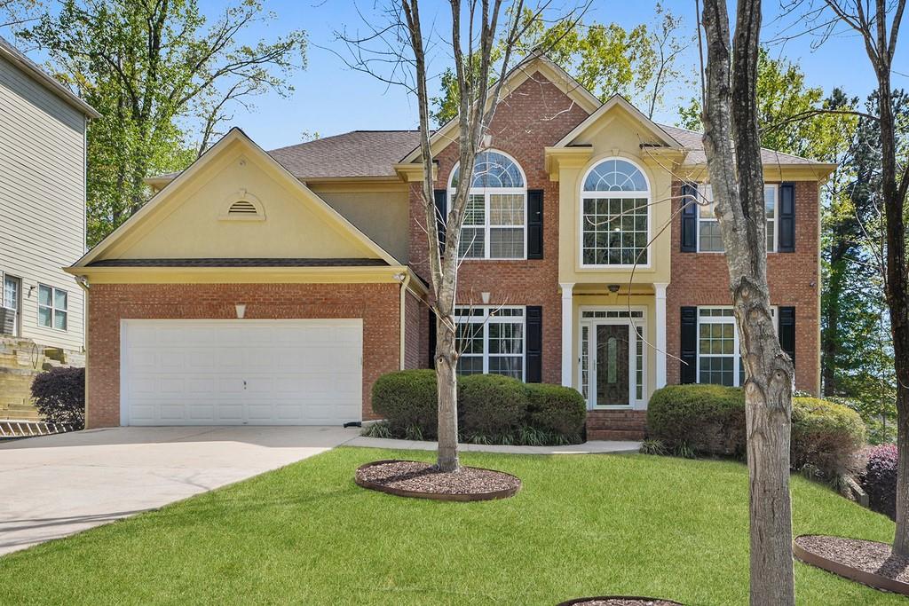 a front view of a house with a yard and garage