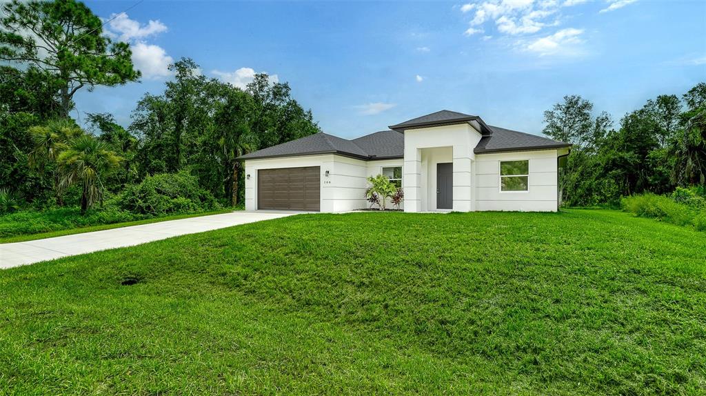 a house with a big yard and large trees