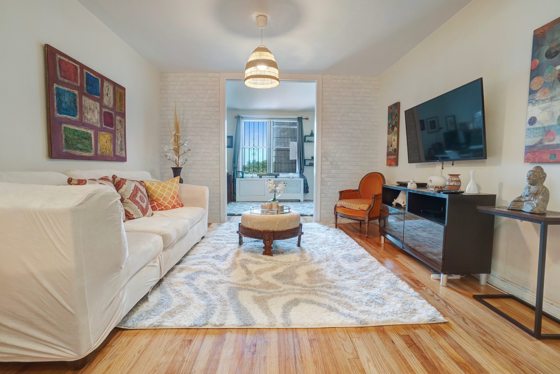 a living room with furniture and a flat screen tv