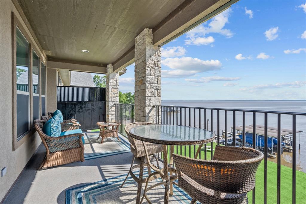 a view of a porch with furniture and a yard