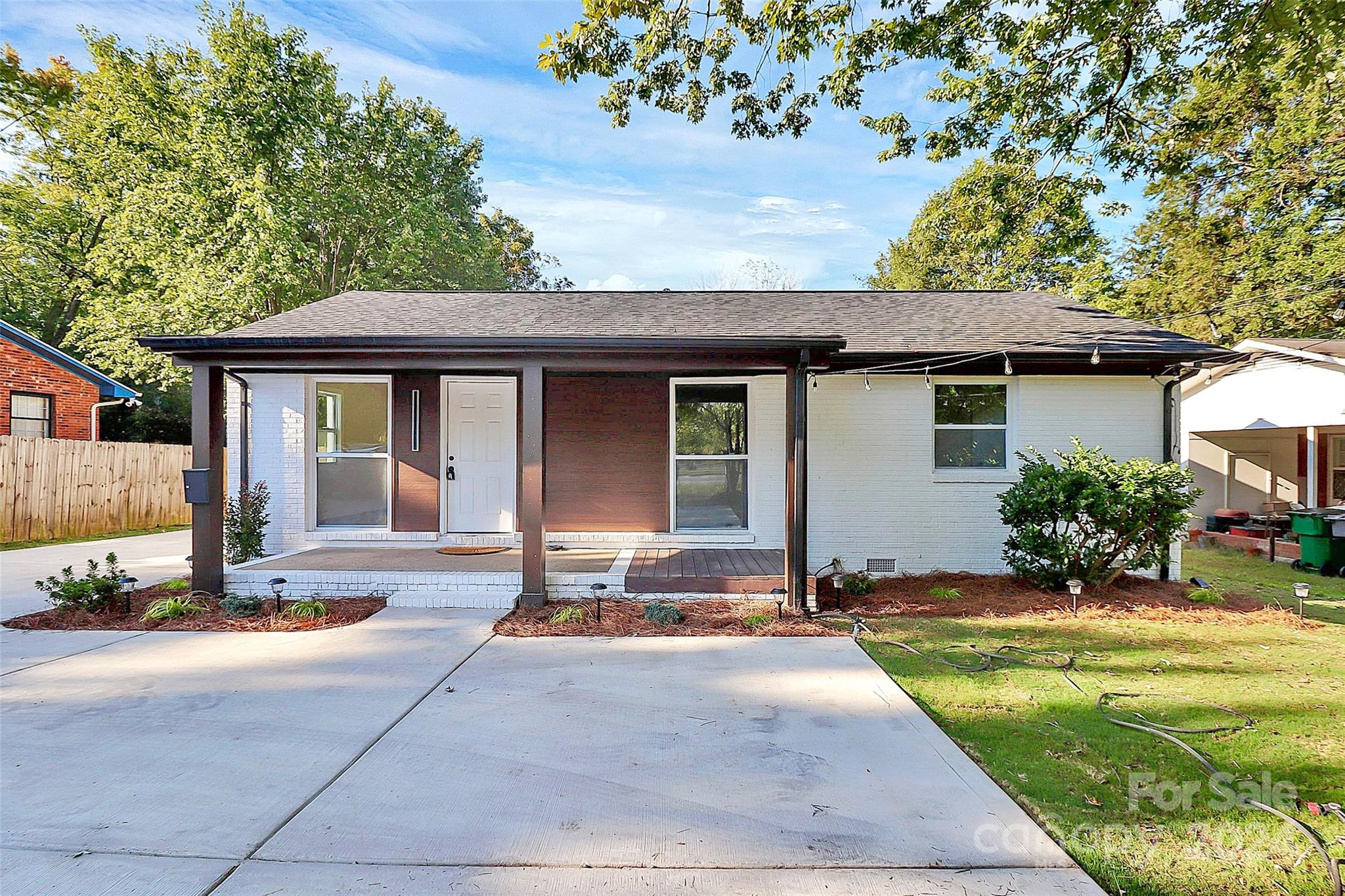 a front view of a house with yard patio and fire pit