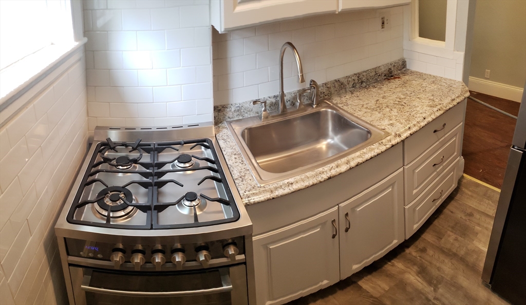 a kitchen with a stove and a sink