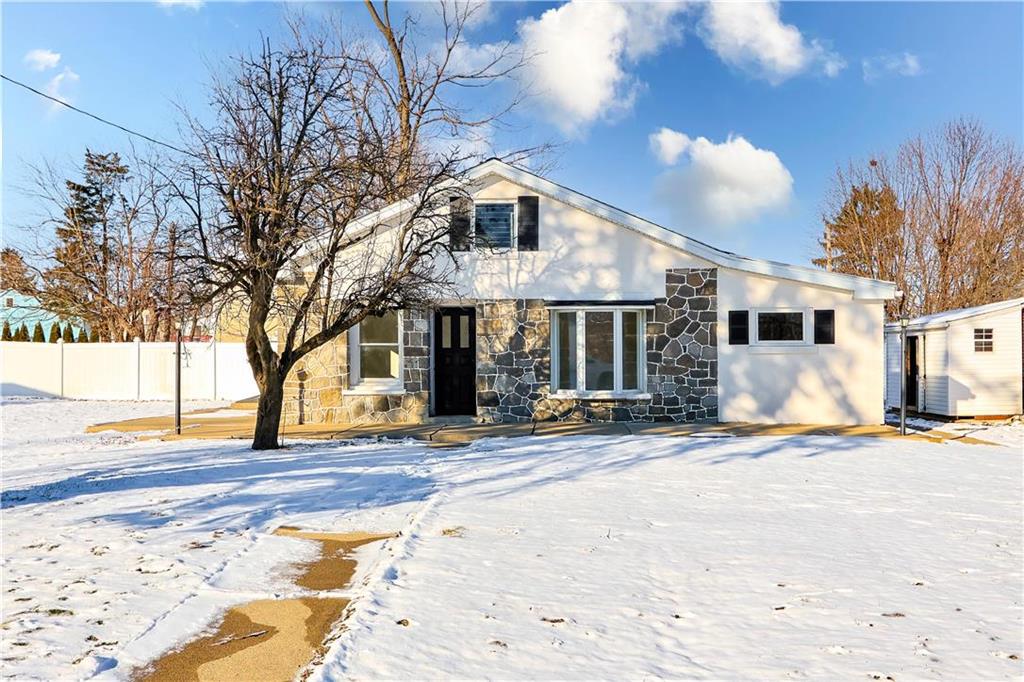 a view of a house with snow on the road