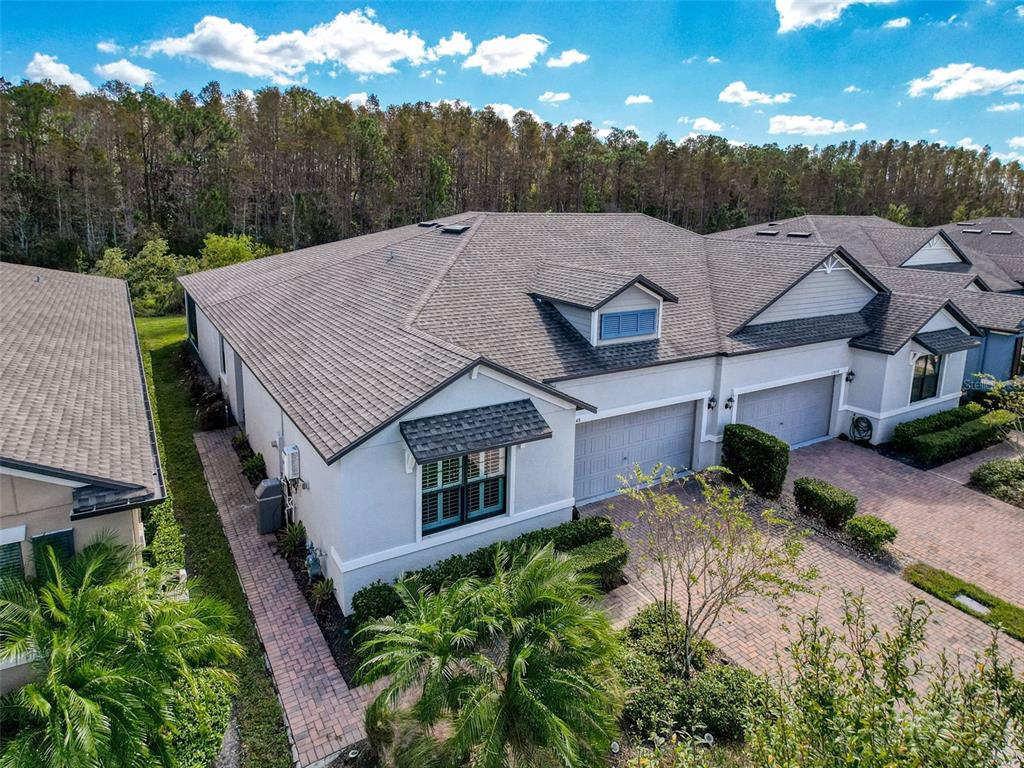 a aerial view of a house next to a big yard