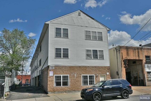 a front view of a house with parking space