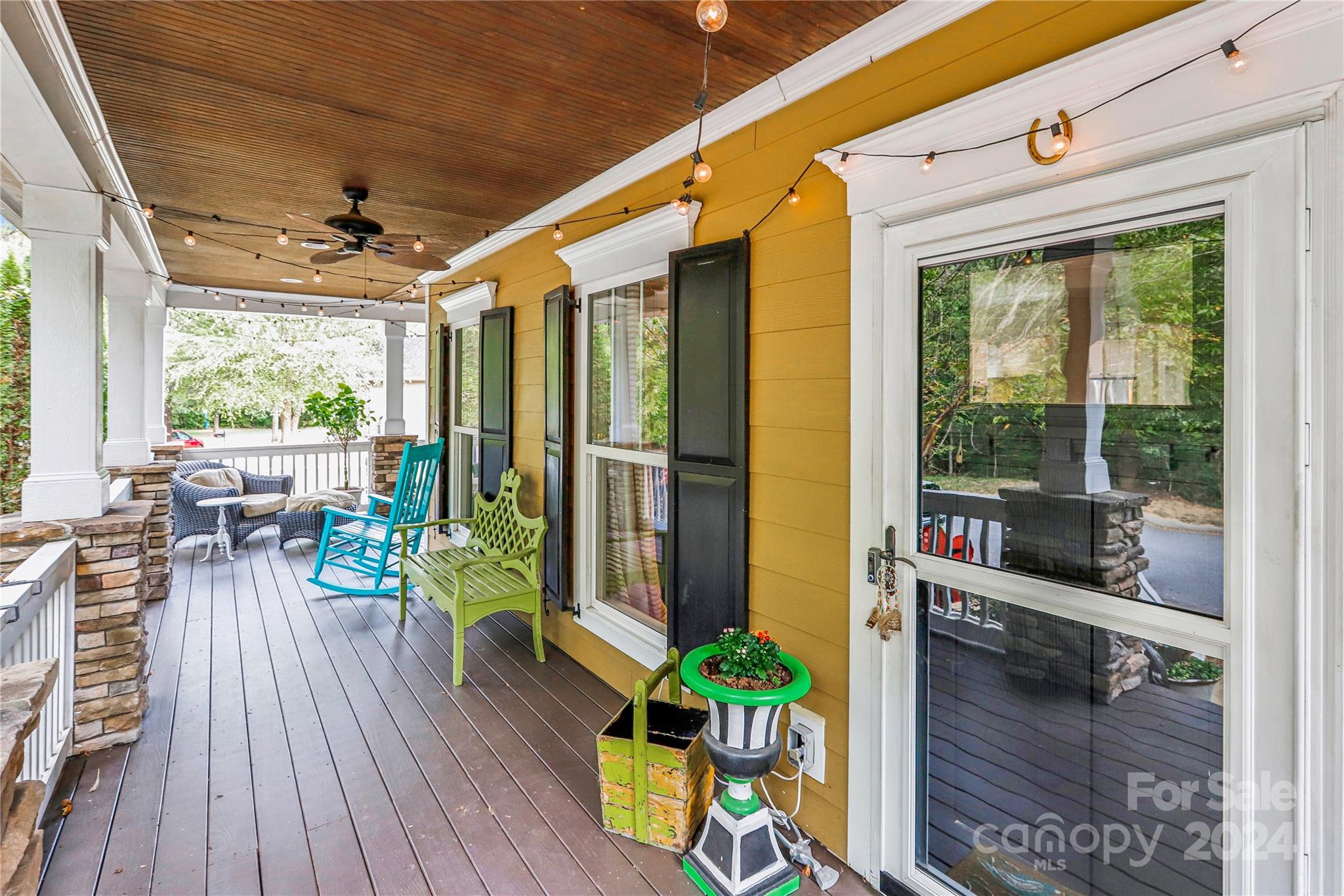 a porch with seating space and a potted plant