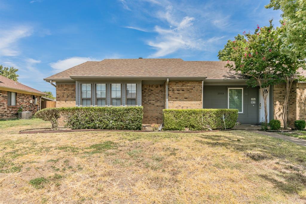 Ranch-style home with a front lawn and cooling unit