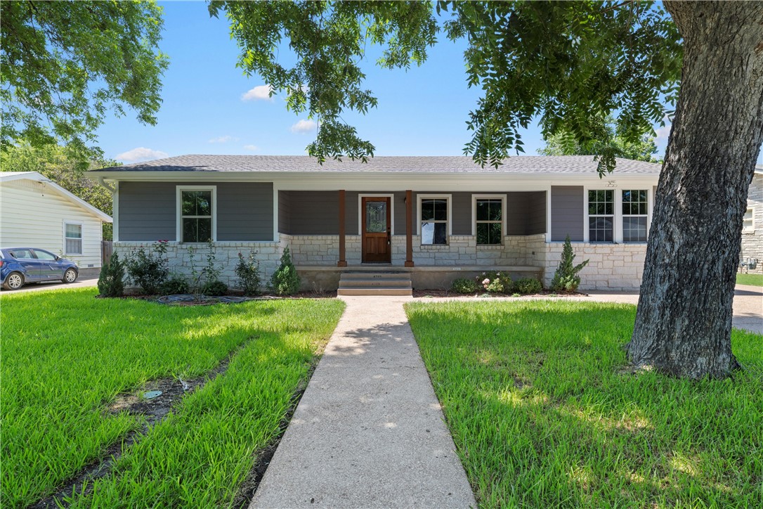 a front view of house with yard and green space