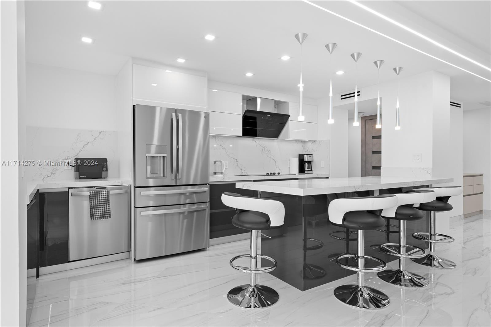 a kitchen with stainless steel appliances granite countertop a sink and a refrigerator