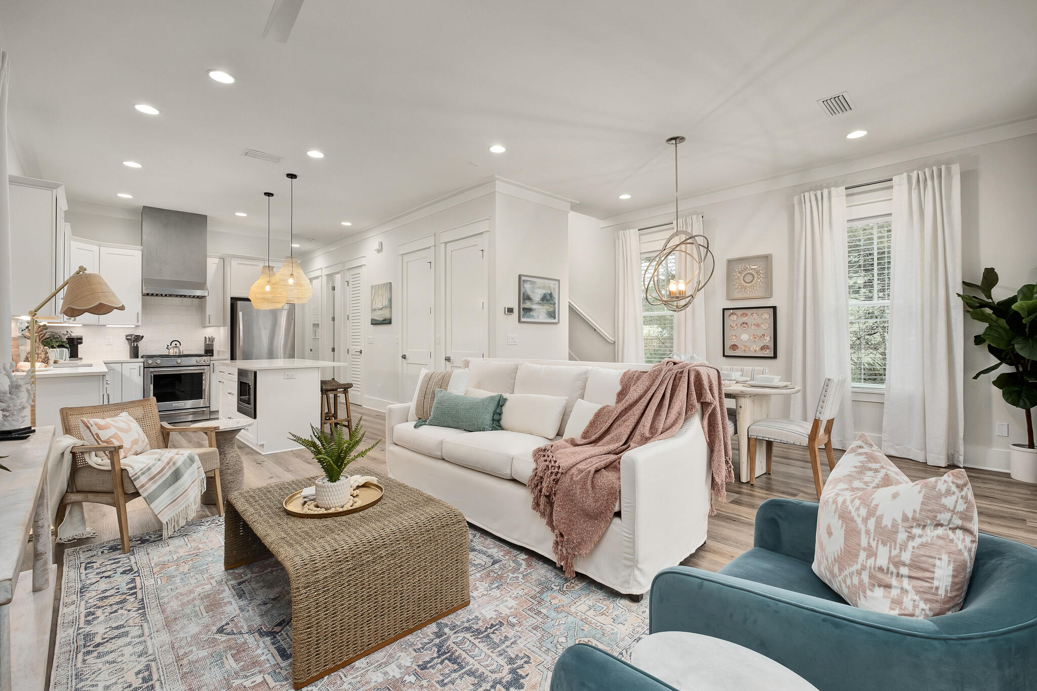 a living room with furniture kitchen and a chandelier