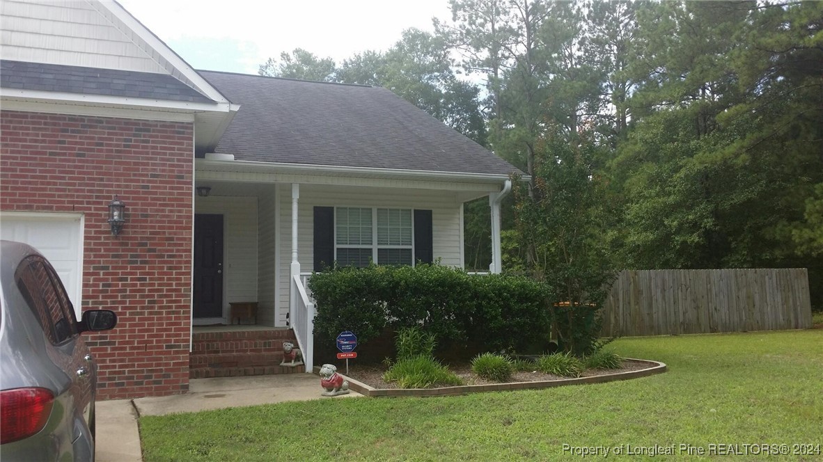 a view of a house with a yard and plants