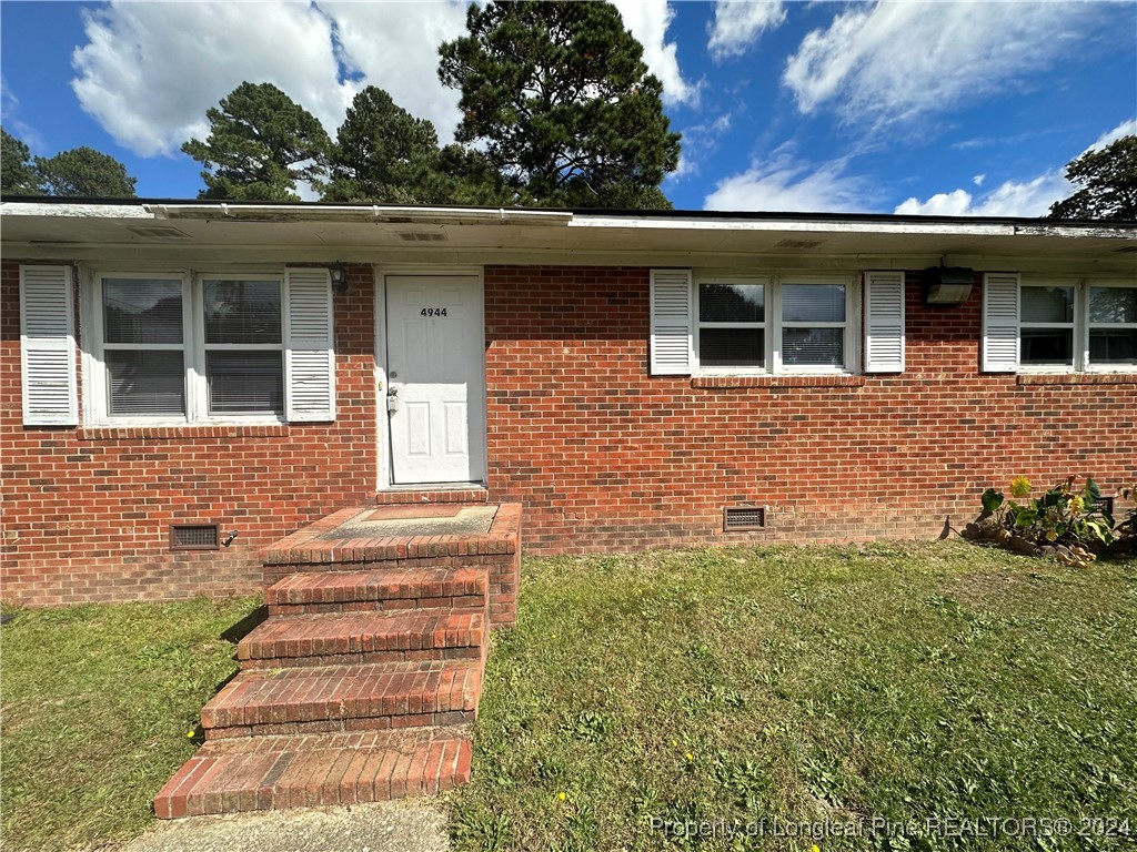 front view of a house with a yard