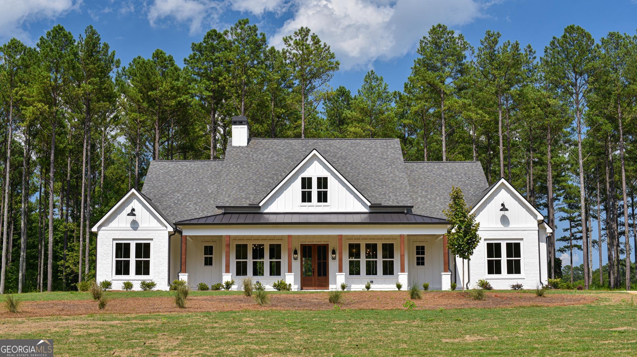 a front view of a house with a garden