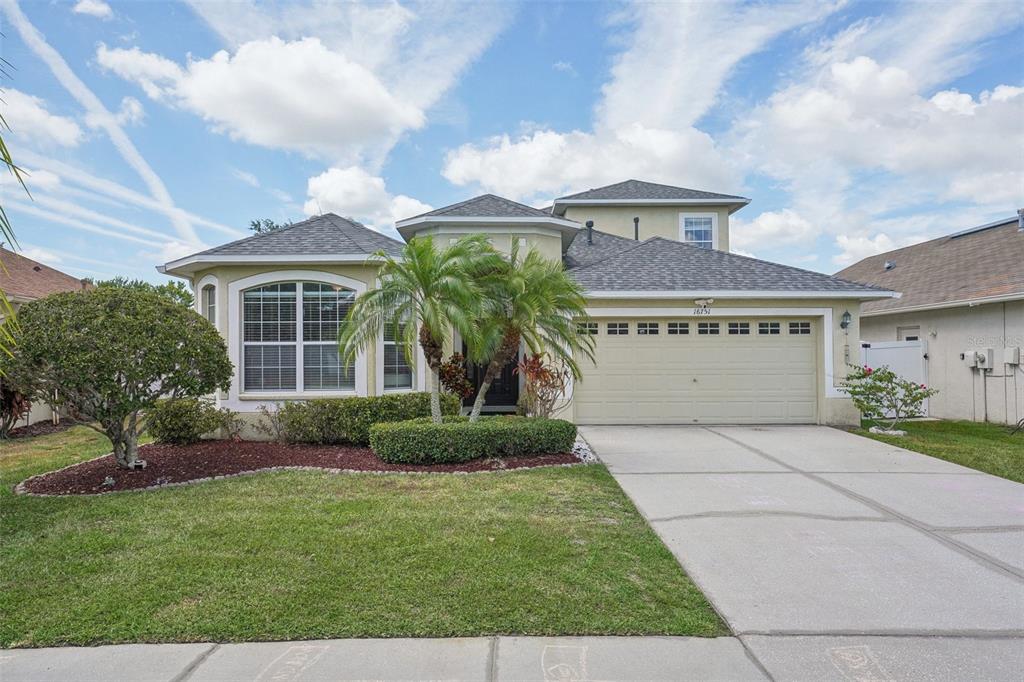 a front view of a house with a yard and garage