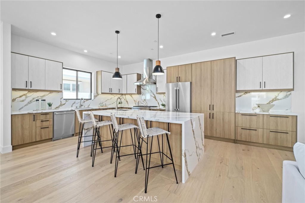 a kitchen with kitchen island granite countertop white cabinets and stainless steel appliances