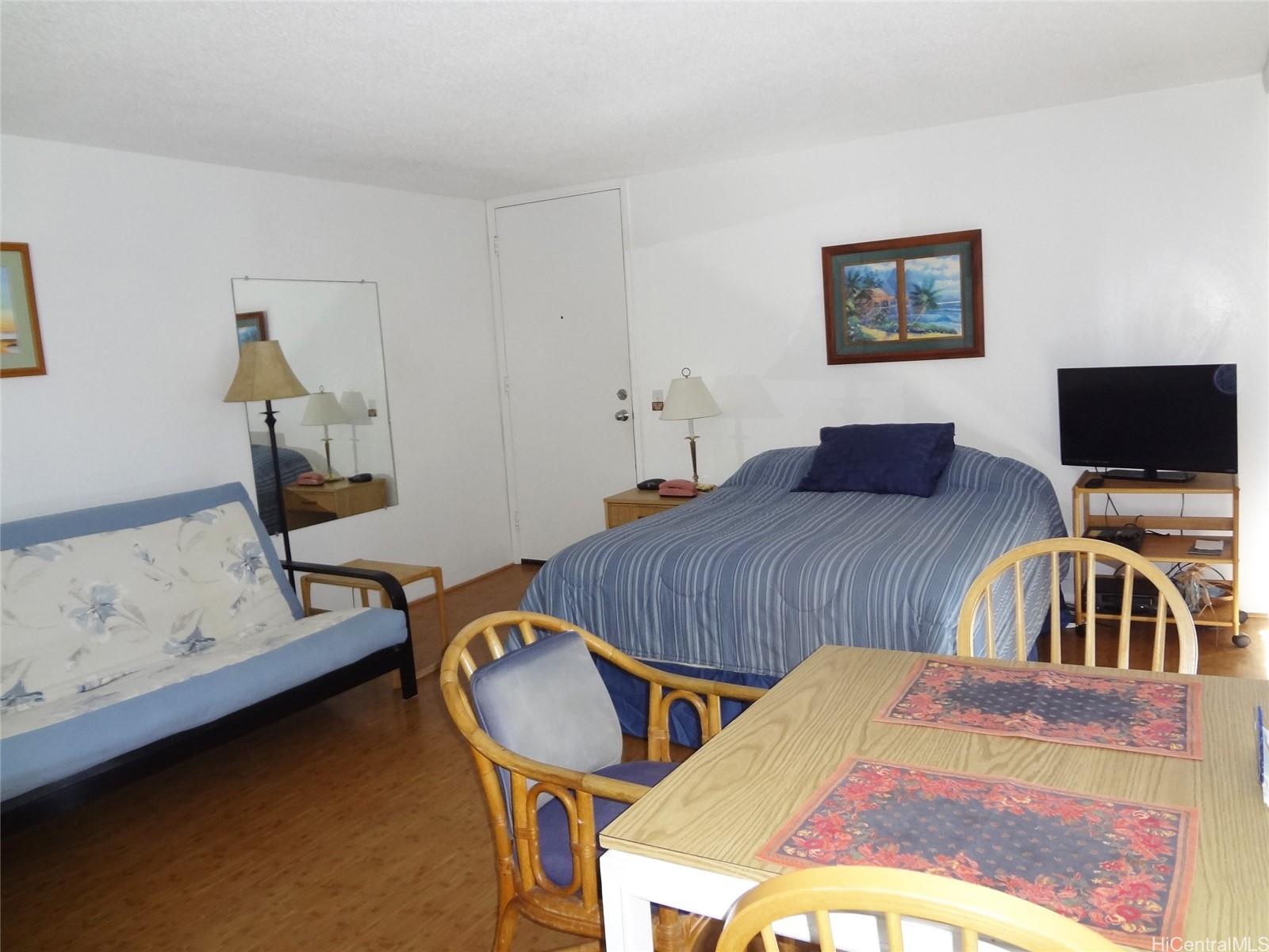 a bedroom with bed and a flat screen tv