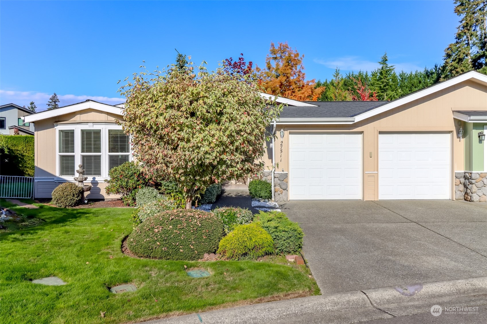 a front view of a house with a yard and potted plants