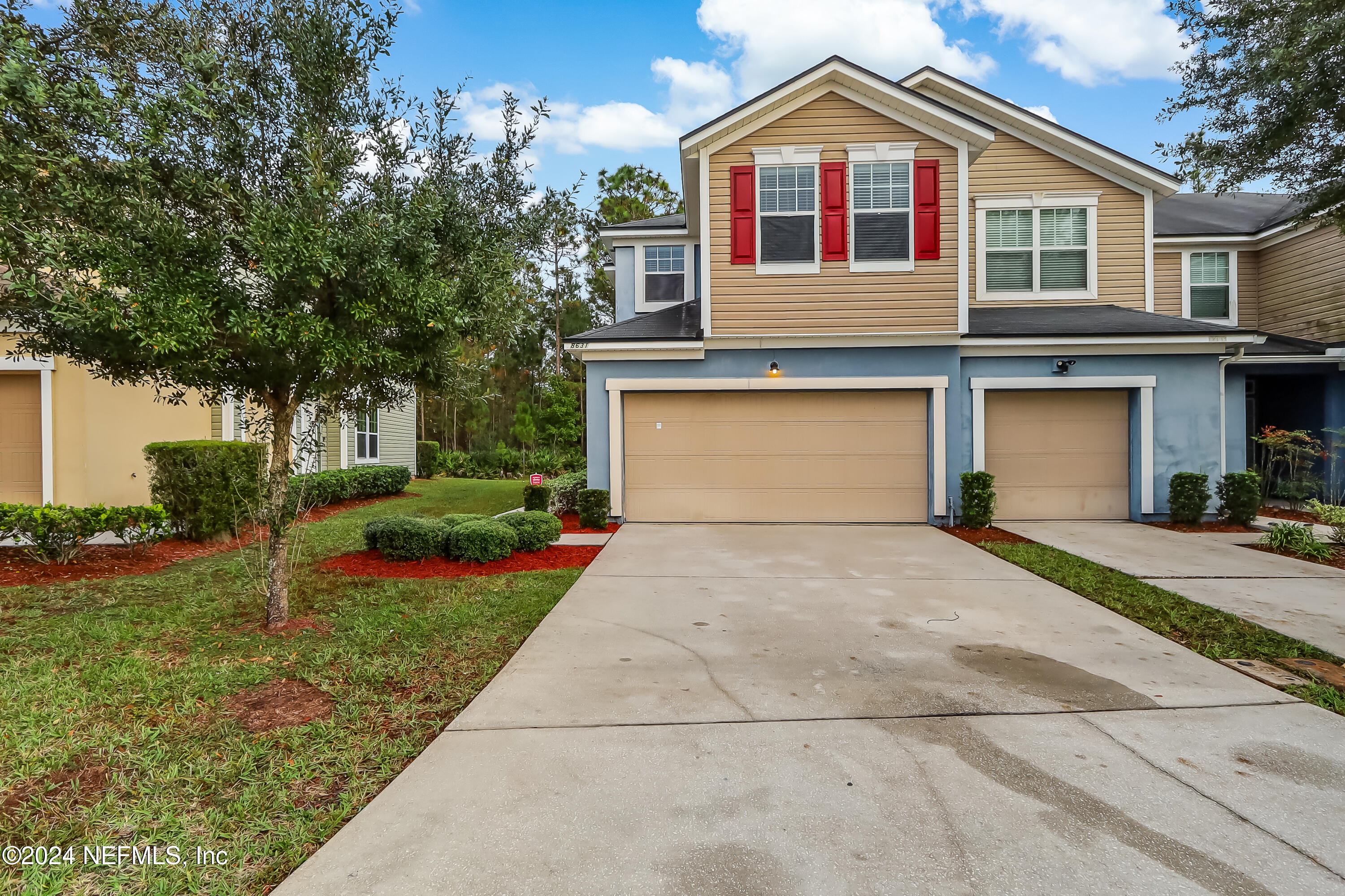 a front view of a house with a yard and garage