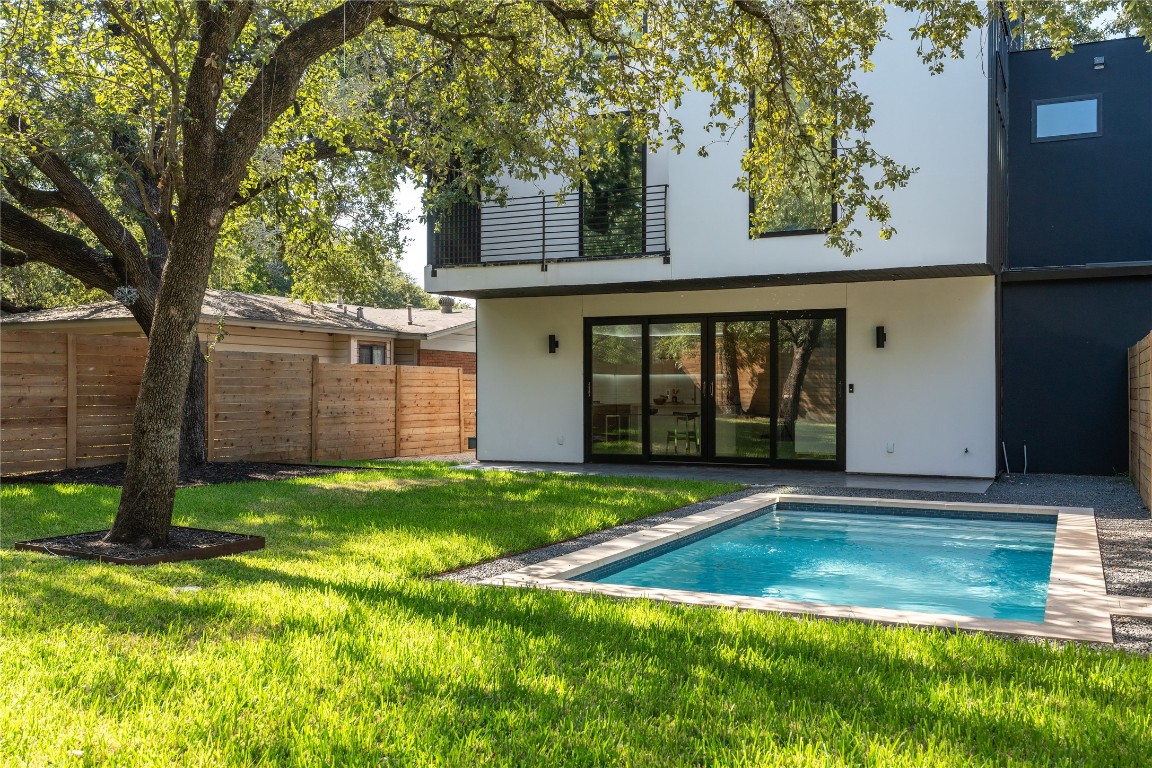 a view of a backyard with a large tree