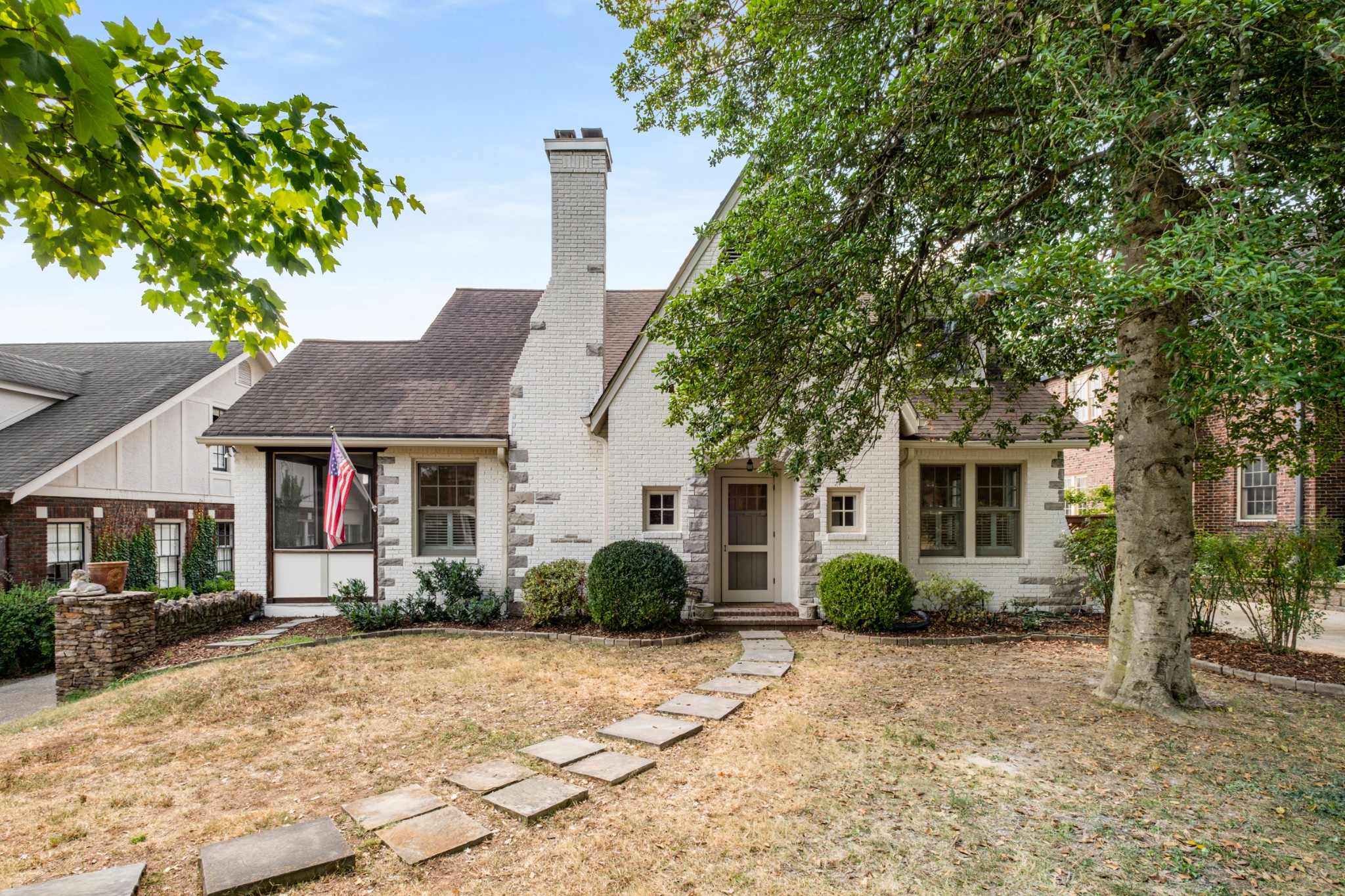 a front view of a house with a garden