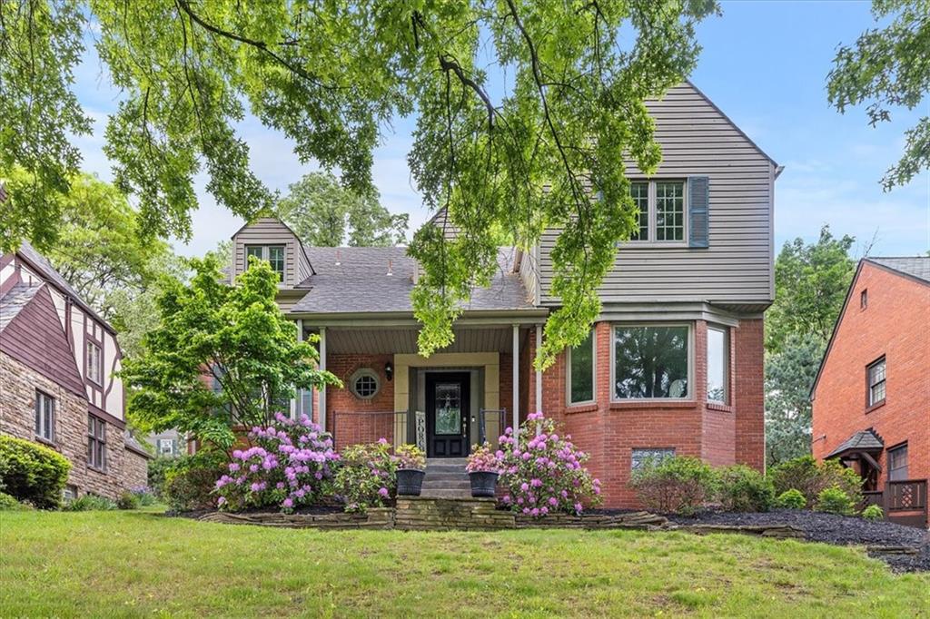 a front view of a house with a garden