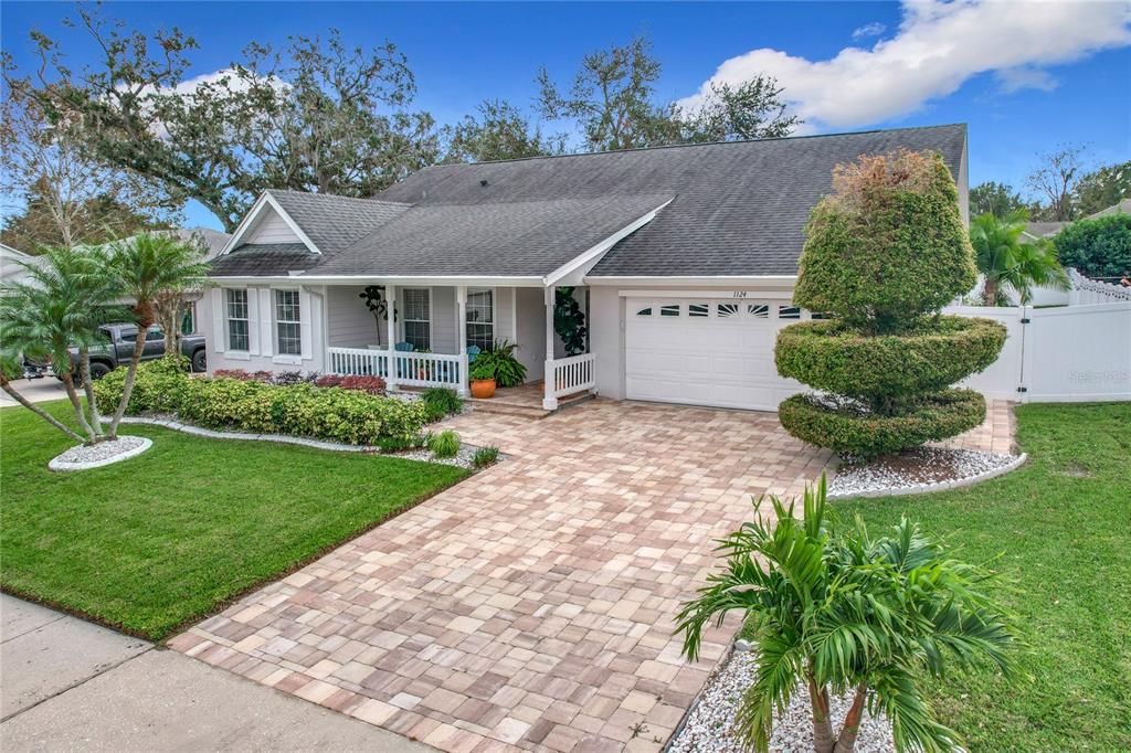 a front view of a house with a garden