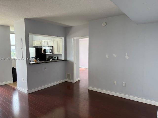 a view of a kitchen cabinets and a wooden floor