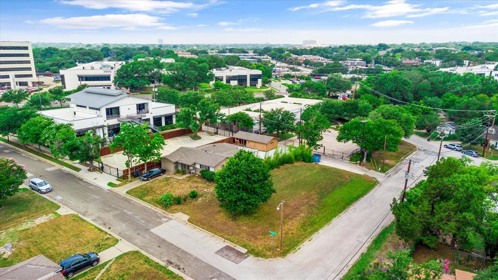 an aerial view of residential houses with outdoor space and street view