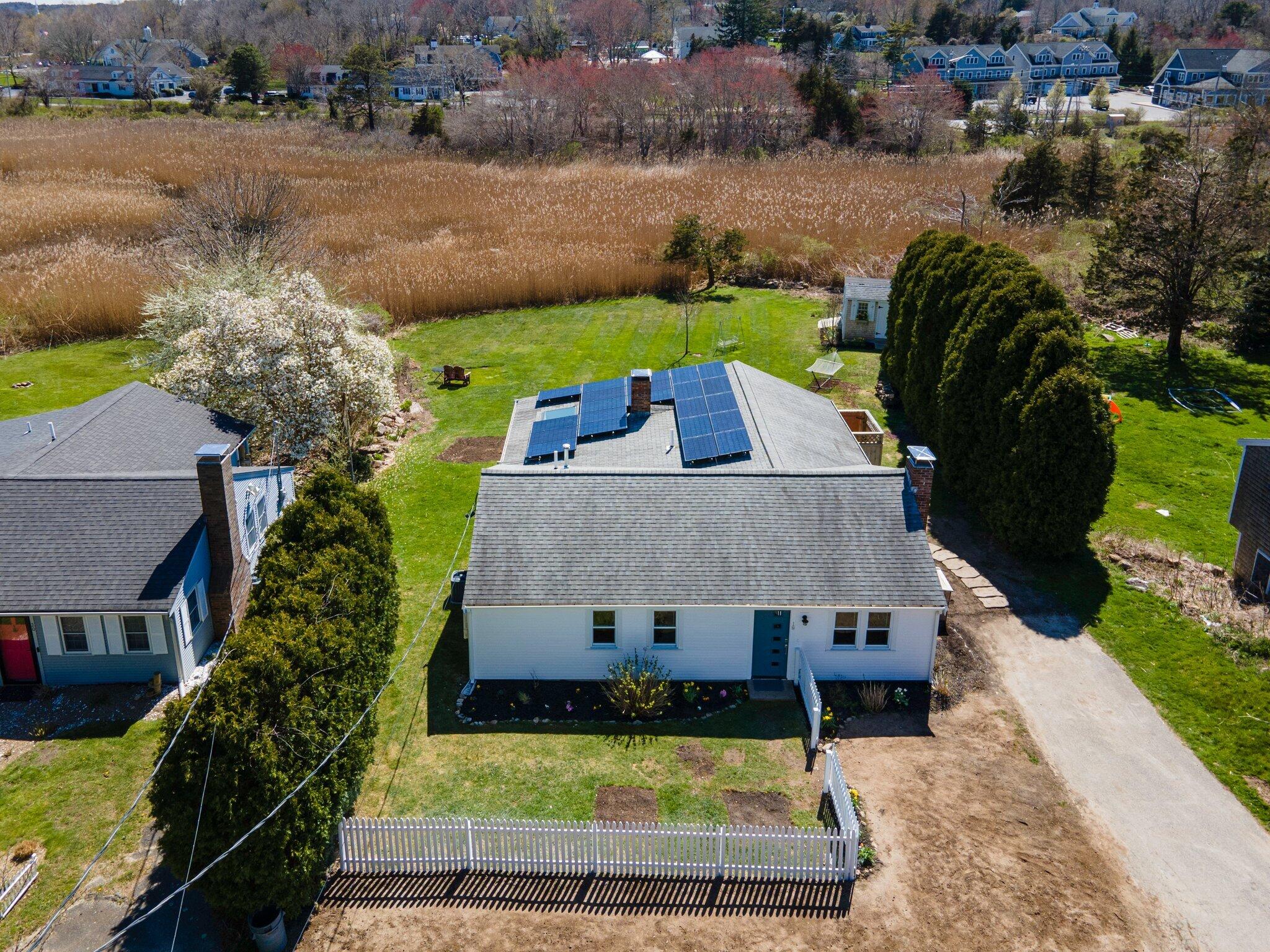 an aerial view of a house with yard swimming pool and outdoor seating