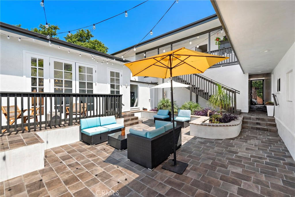 a view of a patio with couches and potted plants