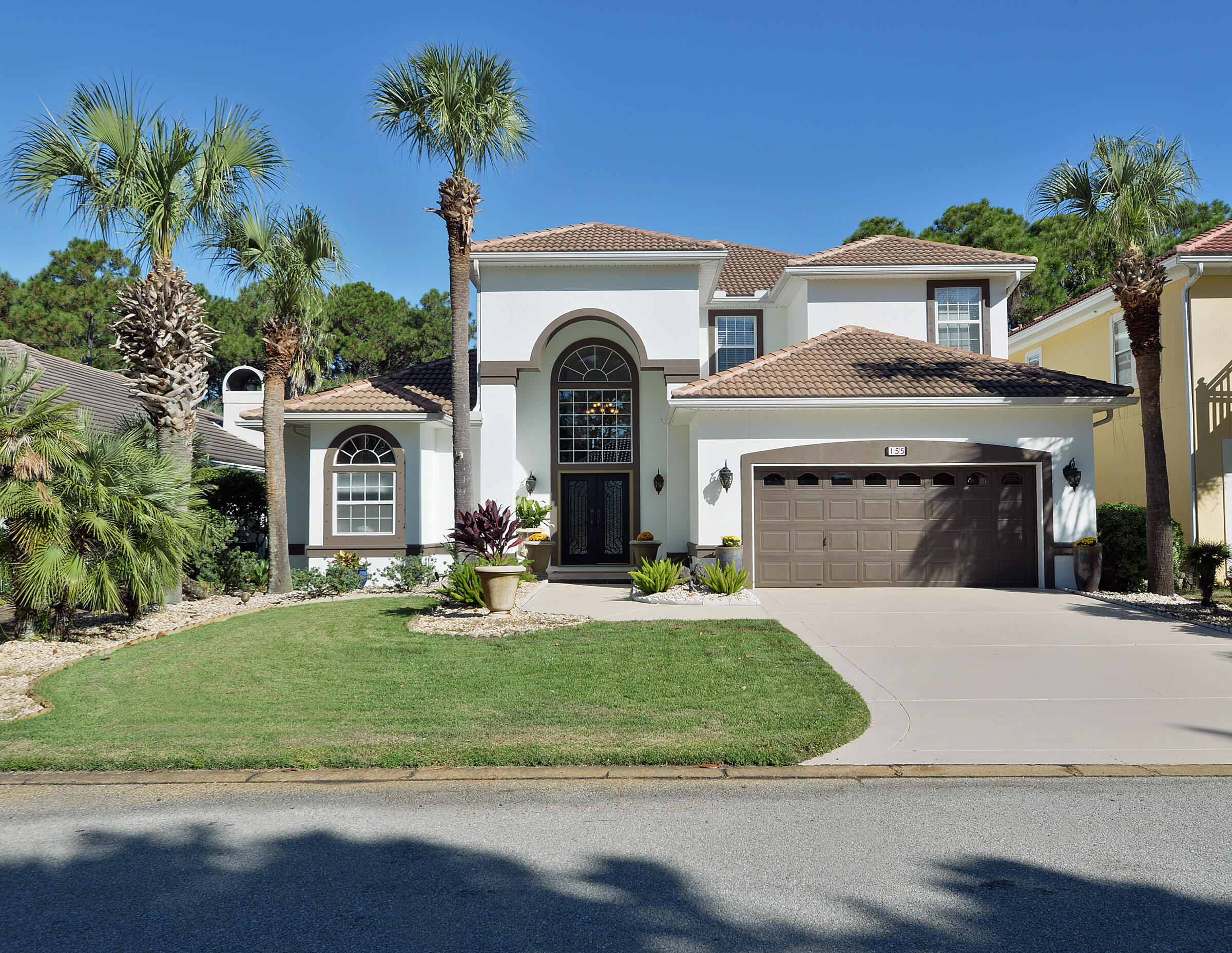 a front view of a house with a garden