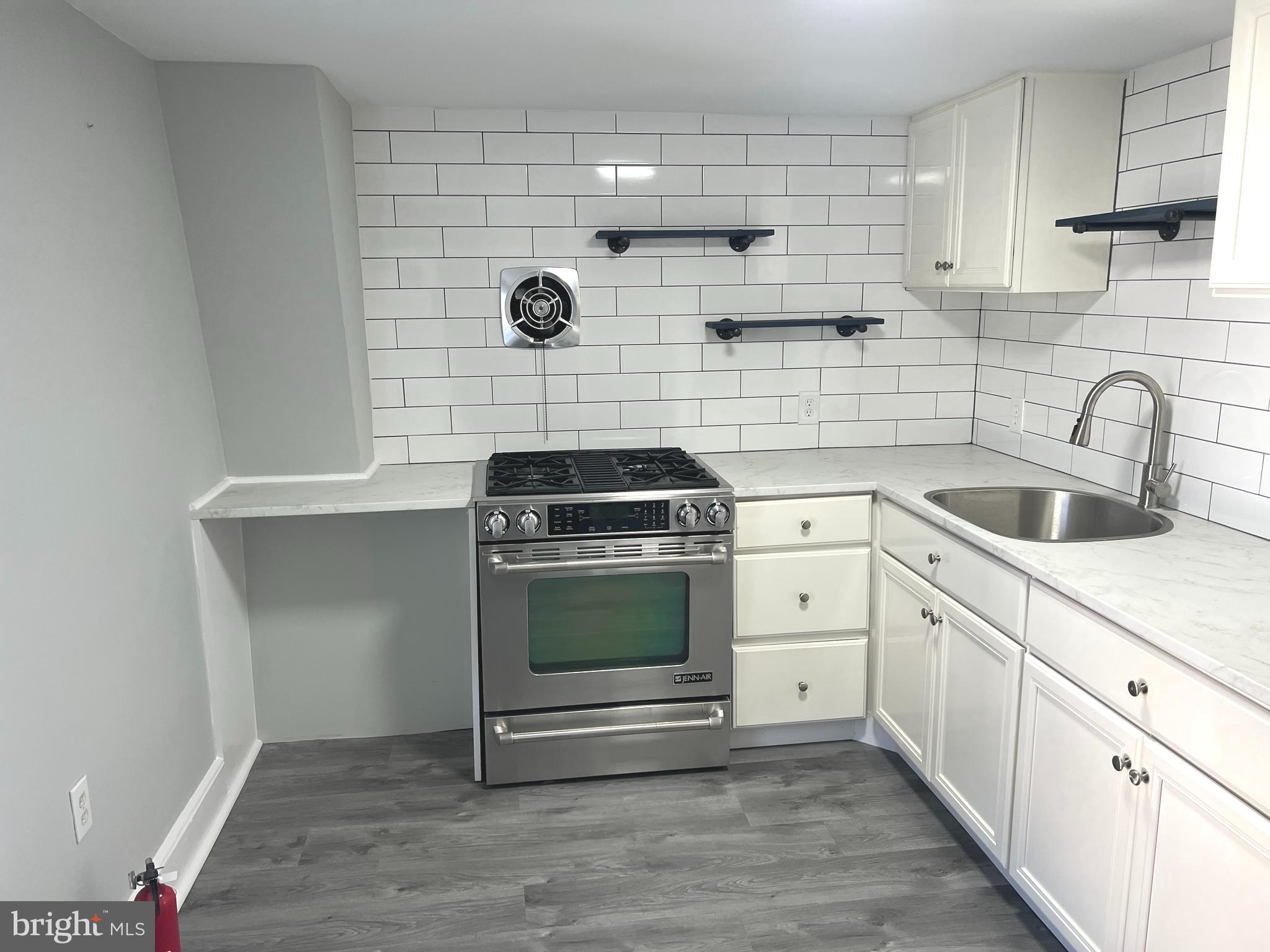 a kitchen with a stove and a sink