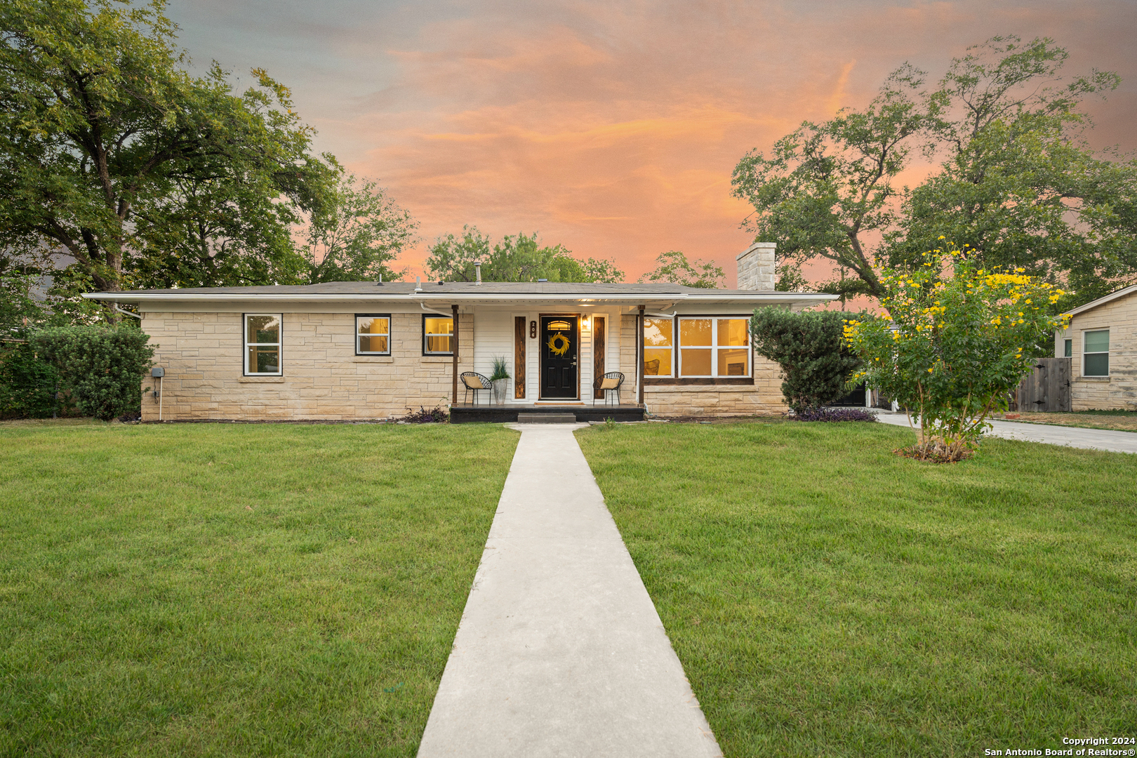 a front view of house with yard and green space