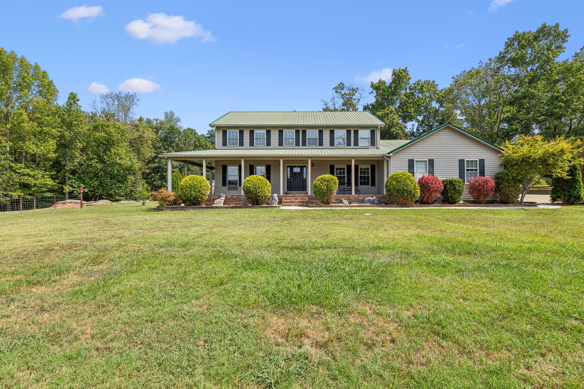 a view of house with outdoor space and garden